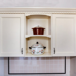 Large country single-wall separate kitchen in Other with recessed-panel cabinets, solid surface benchtops, multi-coloured splashback, ceramic splashback, stainless steel appliances, vinyl floors, no island, multi-coloured floor and brown benchtop.