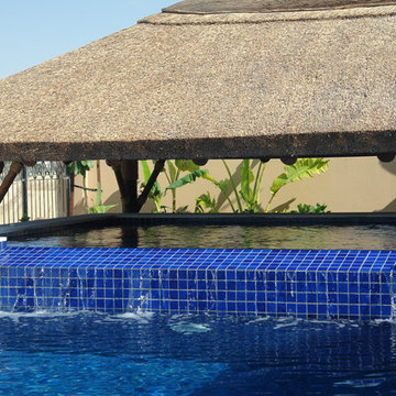 Thatch & timber is the is the focal point of this beautifully landscaped garden