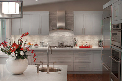Inspiration for a large transitional l-shaped dark wood floor open concept kitchen remodel in Vancouver with an undermount sink, shaker cabinets, gray cabinets, quartz countertops, multicolored backsplash, mosaic tile backsplash, stainless steel appliances and an island