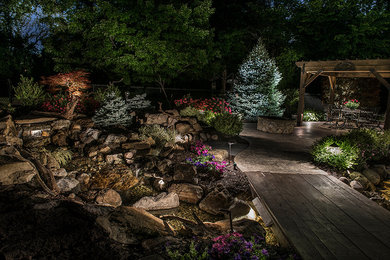 Mid-sized traditional backyard garden in Indianapolis with a water feature.