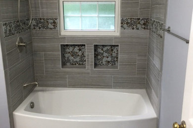 Example of a mid-sized trendy kids' beige tile and porcelain tile porcelain tile and gray floor bathroom design in Las Vegas with flat-panel cabinets, dark wood cabinets, a two-piece toilet, gray walls, an undermount sink and quartzite countertops