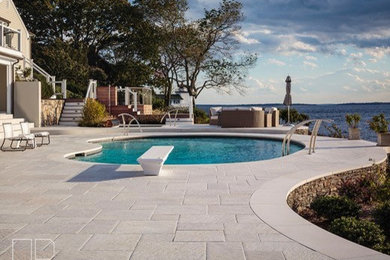 Design ideas for a large modern backyard patio in Providence with concrete pavers and no cover.