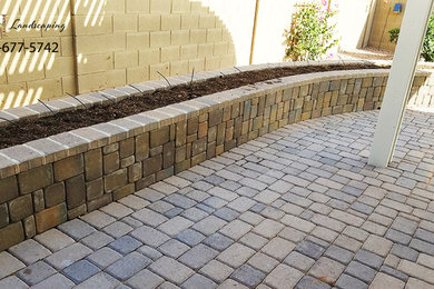 Large courtyard brick patio photo in Phoenix