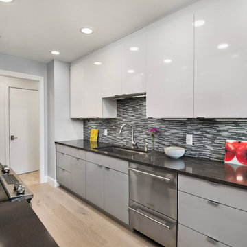 Contemporary High-Gloss Kitchen Remodel | Glass Display Cabinets & Modern Gray B