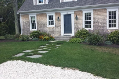 This is an example of a mid-sized traditional partial sun backyard stone landscaping in Boston.