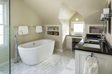 Trendy gray floor freestanding bathtub photo in Minneapolis with green walls, an undermount sink, granite countertops and black countertops
