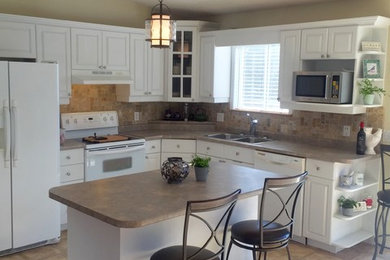 Kitchen - mid-sized transitional l-shaped terrazzo floor and beige floor kitchen idea in Toronto with a double-bowl sink, raised-panel cabinets, white cabinets, laminate countertops, beige backsplash, ceramic backsplash, white appliances and an island