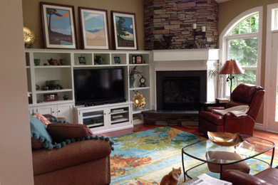 Family room - mid-sized craftsman open concept medium tone wood floor family room idea in Other with beige walls, a corner fireplace, a media wall and a stone fireplace