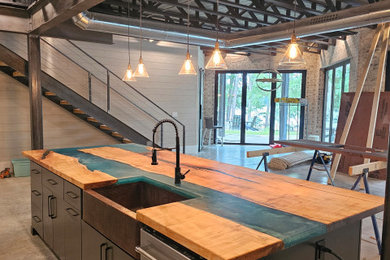 Inspiration for a large industrial concrete floor, exposed beam and brick wall basement remodel in Atlanta with a bar