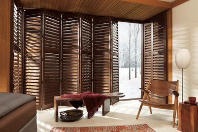 Example of a mid-sized trendy master carpeted and white floor bedroom design in Other with white walls and no fireplace