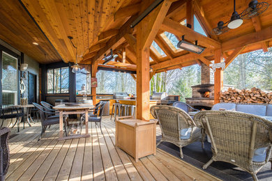 Outdoor kitchen deck - large rustic backyard outdoor kitchen deck idea in Vancouver with a roof extension