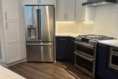 Mid-sized arts and crafts u-shaped laminate floor eat-in kitchen photo in Charleston with an undermount sink, shaker cabinets, blue cabinets, quartzite countertops, white backsplash, mosaic tile backsplash, stainless steel appliances and white countertops