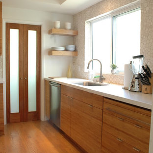 Inspiration for a mid-sized modern u-shaped kitchen pantry in Los Angeles with an undermount sink, flat-panel cabinets, medium wood cabinets, quartz benchtops, white splashback, porcelain splashback, stainless steel appliances and medium hardwood floors.