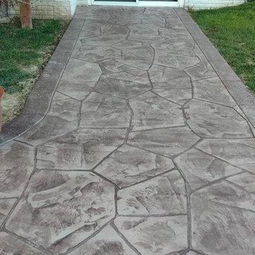 Stamped concrete patio with block seating wall and block fire-pit