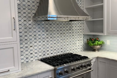 Eat-in kitchen - huge traditional u-shaped cork floor and brown floor eat-in kitchen idea in Other with a single-bowl sink, recessed-panel cabinets, white cabinets, quartzite countertops, blue backsplash, ceramic backsplash, stainless steel appliances, an island and gray countertops