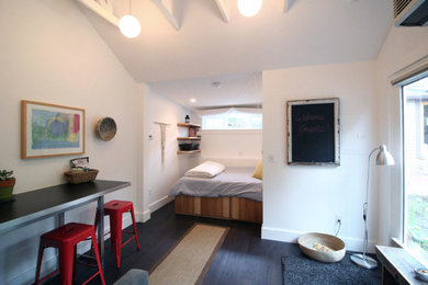Bedroom - mid-sized transitional guest dark wood floor and brown floor bedroom idea in Portland with white walls and no fireplace
