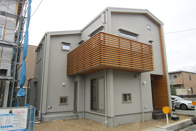 Photo of a medium sized and gey modern two floor detached house in Other with a mansard roof and a metal roof.