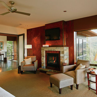 This is an example of a large traditional master bedroom in Other with red walls, carpet, a standard fireplace, a stone fireplace surround and beige floor.