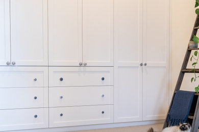 This is an example of a storage and wardrobe in Adelaide with white cabinets.