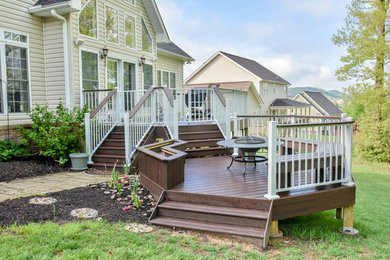 This is an example of a large arts and crafts backyard deck in Other with a fire feature and no cover.