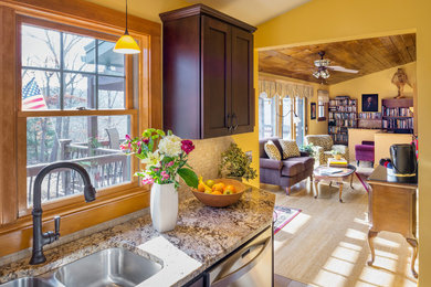 Example of a small mountain style u-shaped porcelain tile eat-in kitchen design in Providence with an undermount sink, shaker cabinets, dark wood cabinets, granite countertops, beige backsplash, porcelain backsplash and stainless steel appliances
