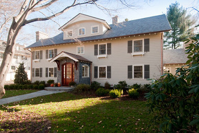Design ideas for a transitional beige exterior in Boston with mixed siding.