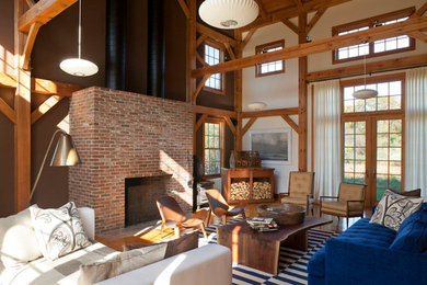Example of a huge transitional loft-style medium tone wood floor family room design in New York with white walls, a standard fireplace, a metal fireplace and a concealed tv