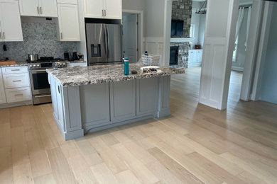 Example of a minimalist light wood floor and beige floor kitchen design in Toronto
