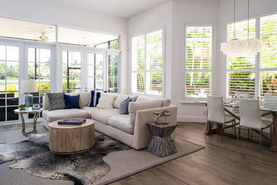 Inspiration for a mid-sized transitional formal and open concept medium tone wood floor and brown floor living room remodel in Miami with white walls, no fireplace and no tv