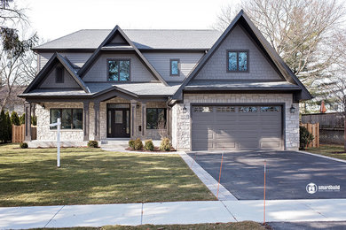 Large elegant gray two-story concrete fiberboard exterior home photo in Chicago with a shingle roof