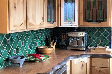 Photo of a small country u-shaped separate kitchen in Phoenix with an undermount sink, shaker cabinets, light wood cabinets, wood benchtops, green splashback, stainless steel appliances, porcelain floors and with island.
