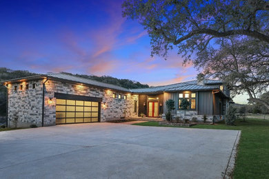 Large trendy gray two-story mixed siding house exterior photo in Austin with a hip roof and a metal roof