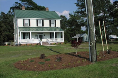 Example of a mid-sized country white one-story concrete fiberboard gable roof design in Other