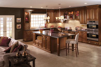 Open concept kitchen - large traditional l-shaped ceramic tile open concept kitchen idea in Chicago with a double-bowl sink, raised-panel cabinets, medium tone wood cabinets, quartz countertops, beige backsplash, subway tile backsplash, stainless steel appliances and an island