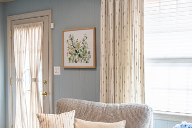 Inspiration for a mid-sized transitional laminate floor and gray floor family room remodel in Other with blue walls