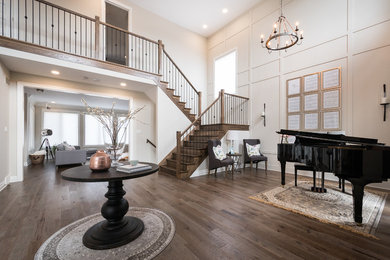 Example of a classic medium tone wood floor entryway design in Other with beige walls