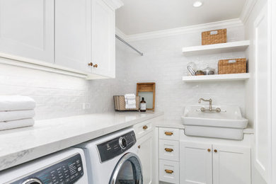 This is an example of a small country l-shaped dedicated laundry room in San Francisco with a farmhouse sink, white cabinets, quartz benchtops, white walls, ceramic floors, a side-by-side washer and dryer, blue floor, white benchtop and shaker cabinets.