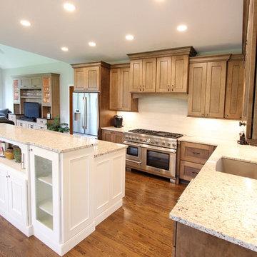 Two Toned Kitchen with White Island and Great Room Stacked Stone Fireplace