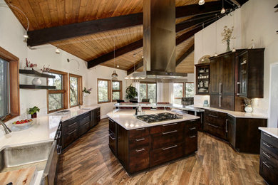 Large country open plan kitchen in Sacramento with a farmhouse sink, flat-panel cabinets, dark wood cabinets, quartzite benchtops, white splashback, ceramic splashback, stainless steel appliances, porcelain floors and with island.
