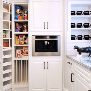 Mid-sized transitional kitchen pantry designs - Inspiration for a mid-sized transitional l-shaped dark wood floor kitchen pantry remodel in Edmonton with an undermount sink, raised-panel cabinets, white cabinets, granite countertops, white backsplash, ceramic backsplash, stainless steel appliances and an island