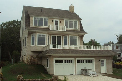 Large traditional three-storey beige exterior in Boston with wood siding.