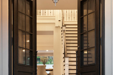 Photo of a large beach style front door in Sydney with white walls, travertine floors, a double front door, a black front door and black floor.