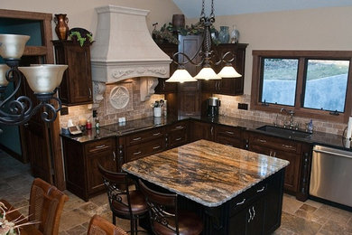 Example of a mid-sized classic l-shaped travertine floor and beige floor eat-in kitchen design in Other with an undermount sink, shaker cabinets, dark wood cabinets, quartz countertops, beige backsplash, stone tile backsplash, stainless steel appliances and an island