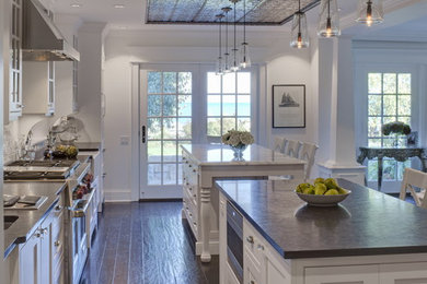 Inspiration for a traditional kitchen in Other with recessed-panel cabinets, white cabinets, multiple islands and black benchtop.