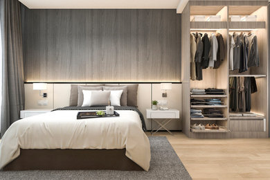 Photo of a contemporary master bedroom in Other with beige walls, light hardwood flooring and a feature wall.