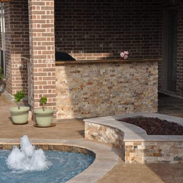 Outdoor Kitchen and Firepit with Travertine Stone Surround