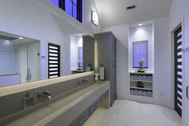 Inspiration for a large contemporary master porcelain tile bathroom remodel in St Louis with recessed-panel cabinets, gray cabinets, white walls, a trough sink and solid surface countertops