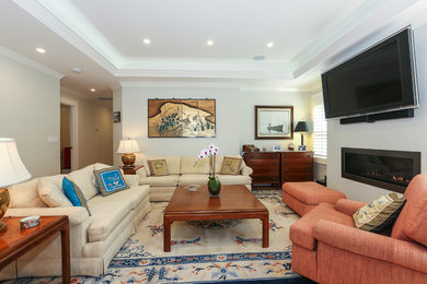 Elegant living room photo in San Francisco with gray walls, a ribbon fireplace and a wall-mounted tv