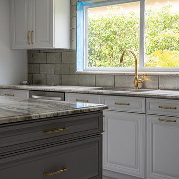 Transitional Kitchen Done in a 2 Tone Color With Integrated Dining Table