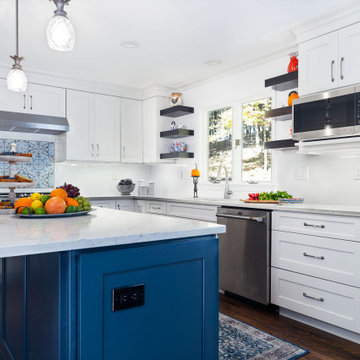 White kitchen with blue island in Long Valley